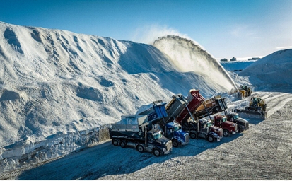Trucks dumping snow at a snow dumping site