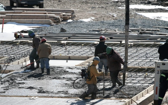 Men pouring wet concrete